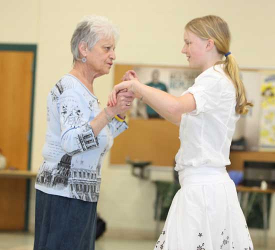 Phyllis Norton (left) helps Katie Toll learn one of the steps.