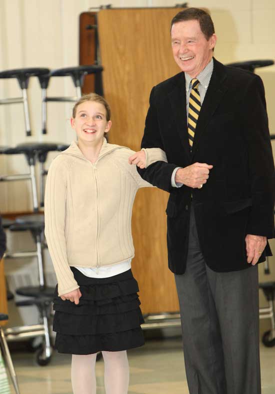 Gwyneth Burns rolls her eyes as she tries to keep up with her dance partner, instructor Richard Norton.
