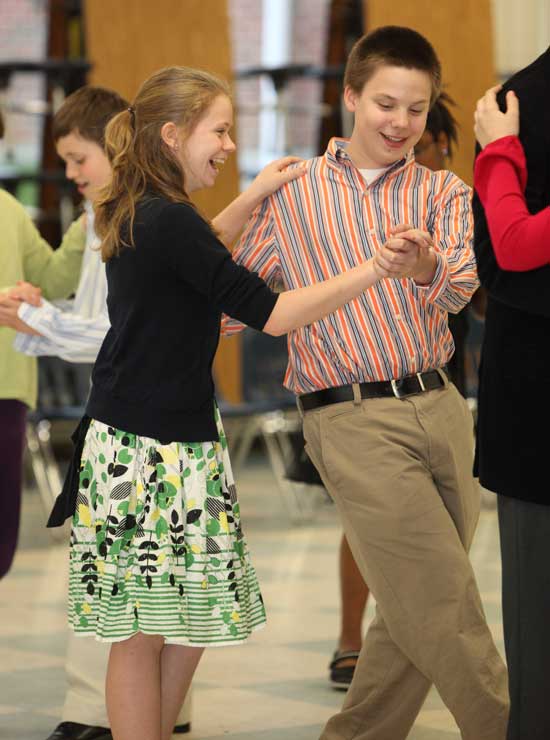 Sixth-graders Jackie Duckett and Jonathan Schmidt try out some fancy footwork during ballroom dancing lessons on April 9.