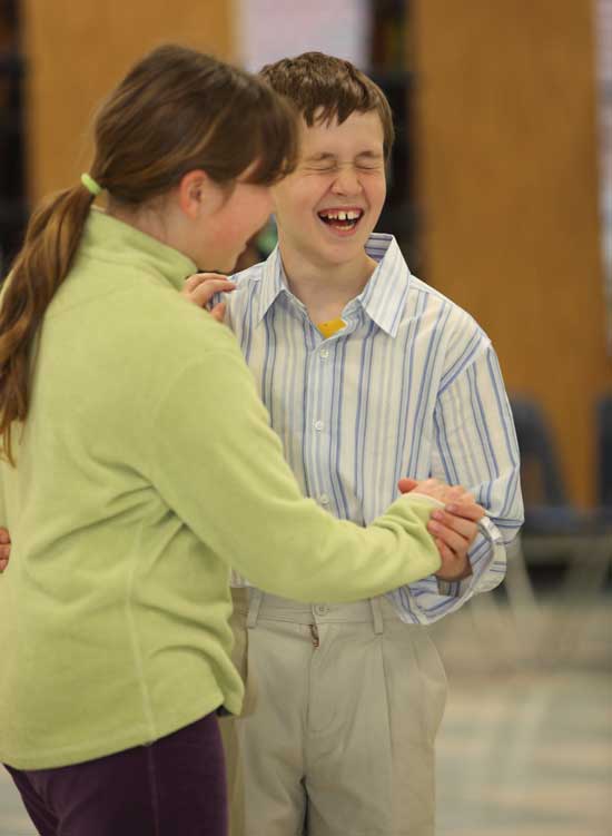 Nick Evans breaks into laughter after botching a dance step with his partner Michelle Ginouves.