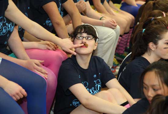 Lorraine Holmes gets her moustache restuck by a friend. Each year the seniors choose a theme for the senior-staff basketball match. This year it was “chicks with moustaches.”