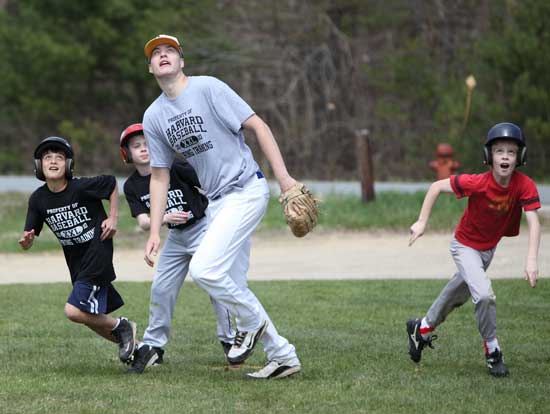 From left: Ben Siddiqui, Scott Jarosz, Jake Lurvey, and Colin Cleary keep their eyes to the sky in a game of pickle on April 20 during a baseball camp run by HAA and the Bromfield varsity baseball team. 