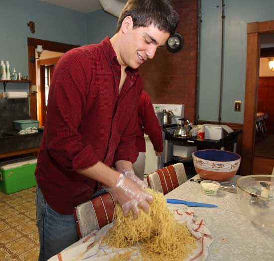 Bromfield senior Clark Jacobson prepares pasta for a crowd at Hildreth House on April 27 as part of his community service project.