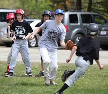 From left: Teammates Colin Grant, Scott Jarosz, and Ben Siddiqui watch as Trevor Granville tries to tag Tippy Brown out in a game of pickle.(Photo by Lisa Aciukewicz)