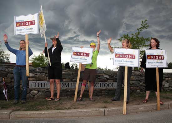From left: Lee Zupancic, Terry Neville, Cindy Buhner, School Committee candidate Kirsten Wright, and Anne Hentz stand in front of the polls on Tuesday, May 4, as a thunderstorm brews.