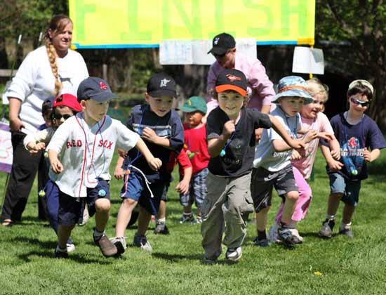 From left, preschool teacher Debi Keller watches as a pack of students including Liam Morrison, William Gothorpe, Alec Vilain, Alex  Myles, Molly Squire, and Tucker Madison completes a mock Boston Marathon on May 5.