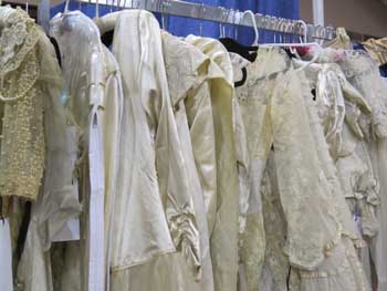 Vintage wedding dresses and other classic gowns are displayed on racks at the tri-annual Antique Textile and Vintage Clothing Show in Brimfield. (Photo by Julie Moberly) Vintage wedding dresses and other classic gowns are displayed on racks at the tri-annual Antique Textile and Vintage Clothing Show in Brimfield. (Photo by Julie Moberly)