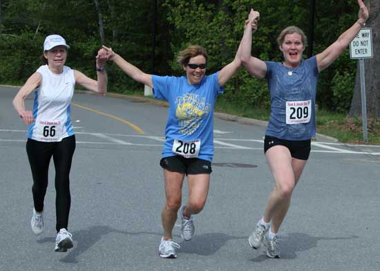 From left: lizabeth Eagan, Audrey Sampson, and Wendy Saydah approach the finish line hand-in-hand.