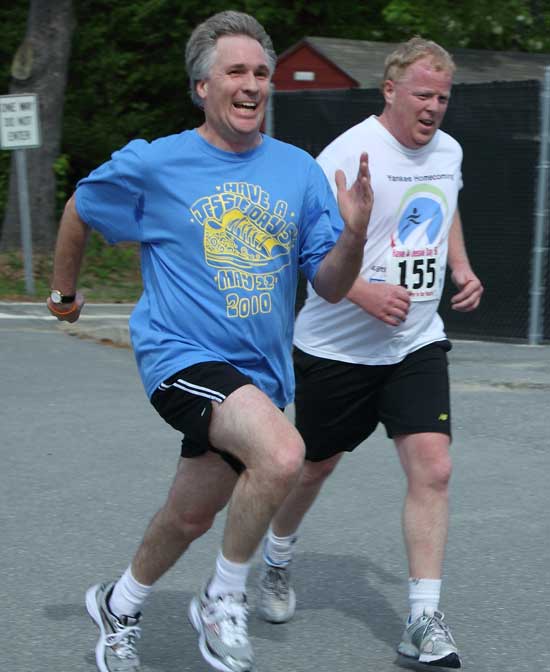 Jessie's father, Eric Peterson, finds a last-minute burst of energy as he sprints past Larry Miller just before the finish line.