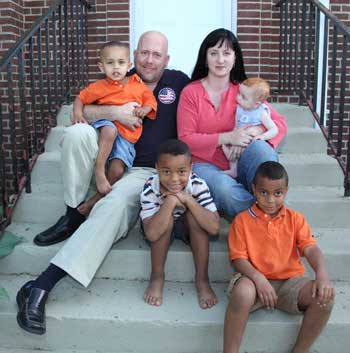 The Graham family poses in front of their home. From left: Takoda, Shawn, Javen, Amy, baby Ava, and Elijah. (Photo by Lisa Aciukewicz)