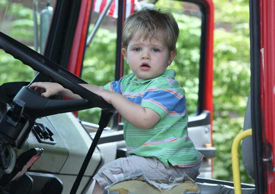 Tyler Reynolds of Marlborough tries out the horn on a dump truck at the Touch-a-Truck event sponsored by the Village Nursery School on Saturday, May 22.