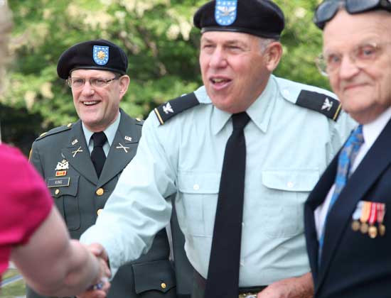 From left, David King, the Memorial Day speaker, greets people with Duane Barber and Roland Martineau.