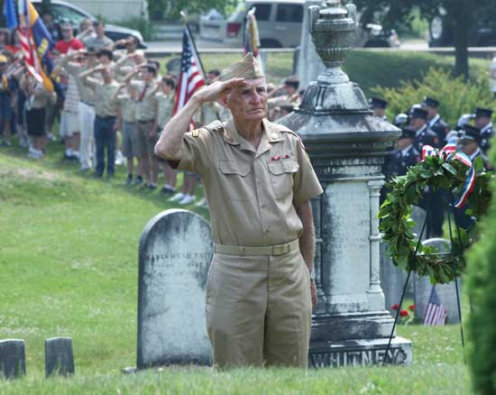 Korean Conflict veteran Peter Johnston stands at attention after placing a wreath in front of the Founders’ Memorial on May 31.