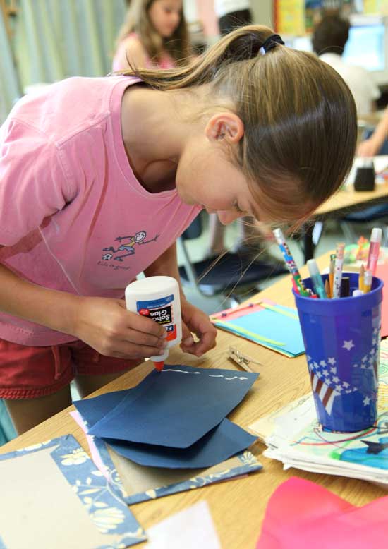 Taylor Tracey puts glue on the end pages of her book.
