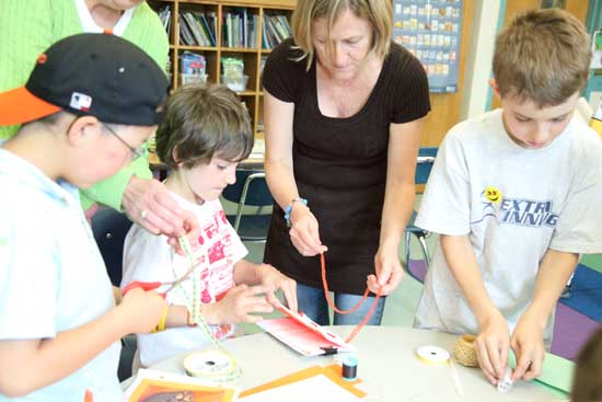 Kate Pullano (center) helps George Shen, Huner Carroll, and Matthew Carrona.