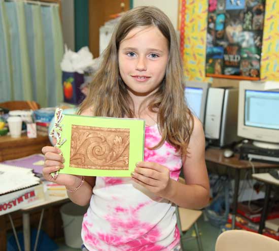 Beatrice Wig shows off the cover of her book.