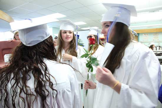 Milana Abidor, Masha Tsapenko (center),and Brittney Davidson wait in the elementary school library for the graduation ceremony to start.