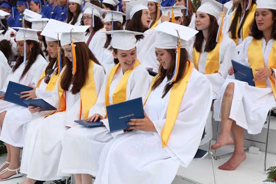 New graduates check out their diplomas. Front row, from left: Milana Abidor, Alessandra Pastor, Kailee Rubin, Megan Harrington, and Catherine Spacciapoli. Back row: Kate Oglesby, Megan Vilcans, Sam Eccleston, Lauren Tower, and Nikki Snyder.