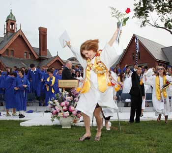 Rebecca Turner springs off the stage at the end of Bromfield’s 2010 graduation ceremony. (Photo by Lisa Aciukewicz) 