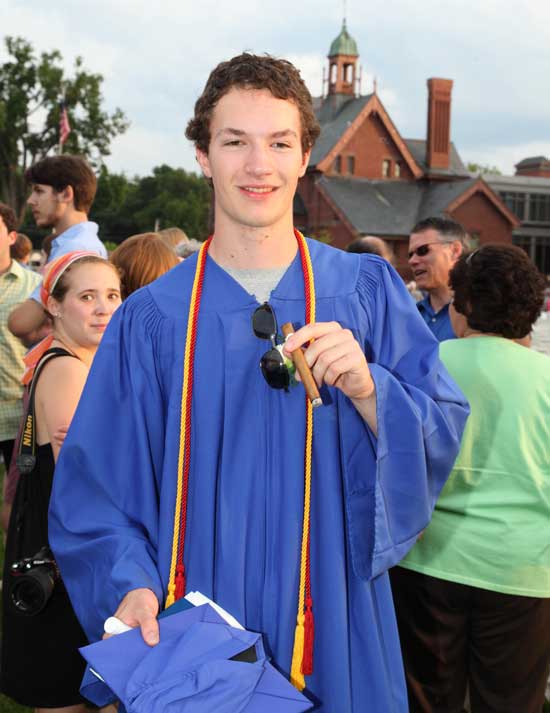 New graduate Will Blackwell smokes a cigar after the ceremony.