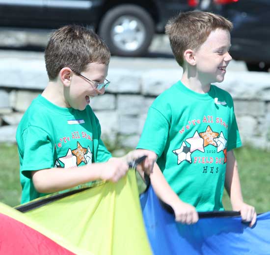 Colin McHugh and Patrick Sullivan share some giggles as they hold on to a slippery parachute.