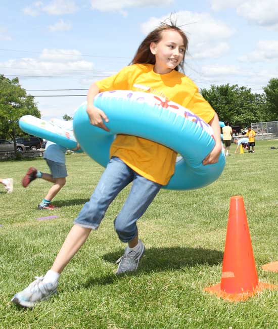 Fifth-grader Rebekah Lindsey rounds the cone in a relay race.