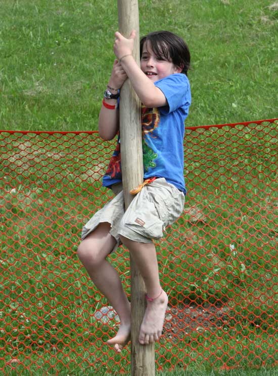 Reese Stevenson tries his skill climbing the greased pole.