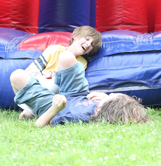 Sam Hoffman and Josh Fishbein collapse in laughter after running through the obstacle course.