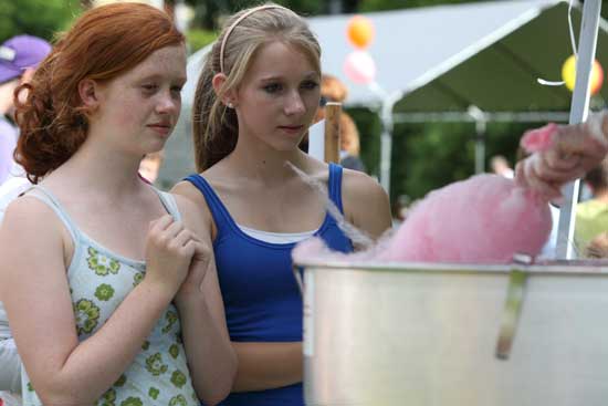Seventh-graders Eve MacMahon and Kirsten Sundeen wait in anticipation for their cotton candy.