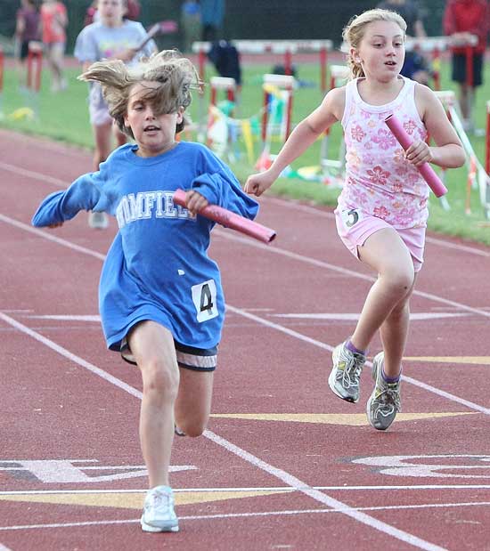 Nina Sklar (left) beats her opponents to the finish line in a close 400-meter relay at the Hershey Track events at McCurdy Track on June 18.