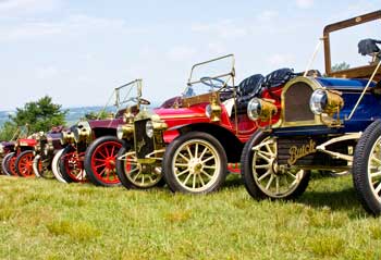 Antique cars on tour from Gardner rest on the lawn at Fruitlands as their drivers eat lunch in the tea room on June 24. (Photo by Tyler Papazian)