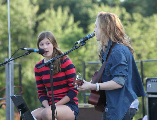Emma Noyes (left) and Ashley Jordan entertain the crowd at Fruitlands before the fireworks display starts.