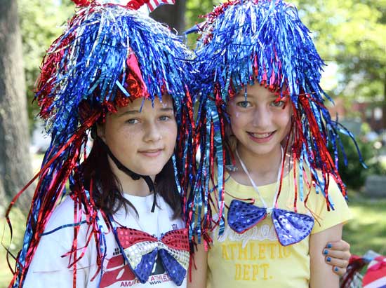 Jenny Andrews and Carolyn Garvey pose with matching wigs before the start of the parade.