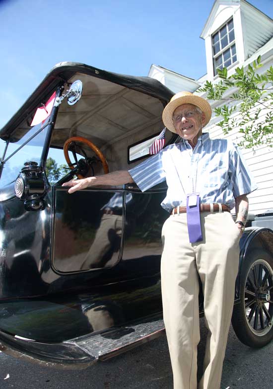 Larry Gould of Chelmsford poses with a 1905 Cadillac that he drove in the parade.