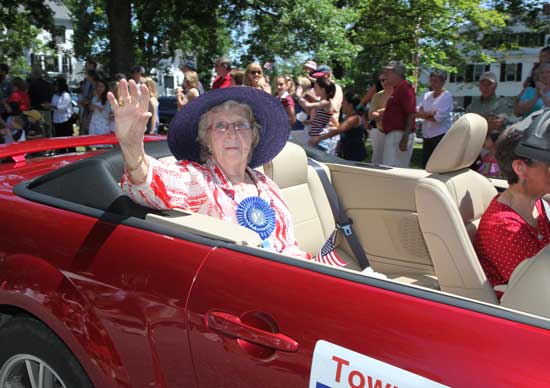 Parade Grand Marshal Phyllis Newman waves to the crowd from Lucille Hughes’ convertible.