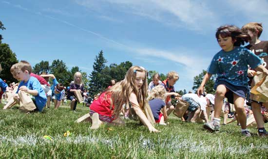 Children search the grass in the candy scramble.