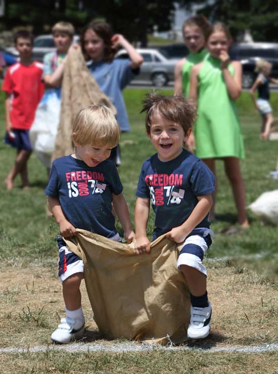 Brothers Thomas and Kevin Cardosa head toward the finish line in the under-5 heat of the three-legged race.