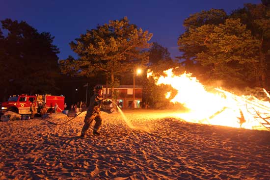 The annual end-of-the-season bonfire burns out of control on Aug. 6 at the town beach as the Fire Department shows up to help.