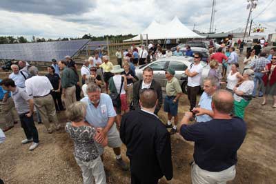 A crowd of well wishers gathers next to the new solar array at Carlson Orchards on Oak Hill Road for a ribbon-cutting ceremony for the largest agriculture solar array in the state.  (Photo by Lisa Aciukewicz)