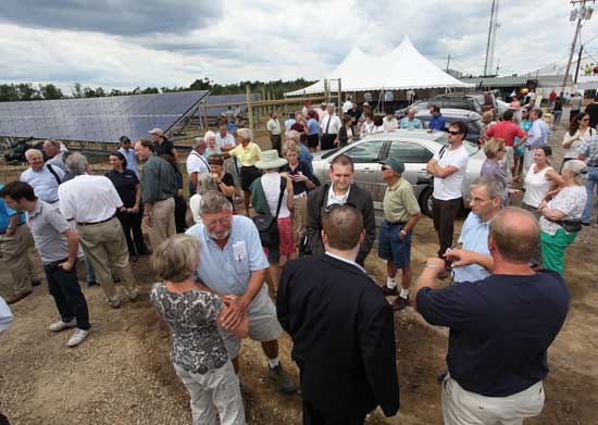 A crowd of well wishers gathers at the solar array at Carlson Orchards after a ribbon-cutting ceremony on Aug. 13 for the largest agricultural solar array in the commonwealth. 