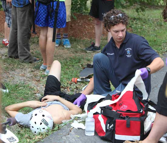 Harvard EMT Will Blackwell attends to injured boarder Jeffrey Vyain.