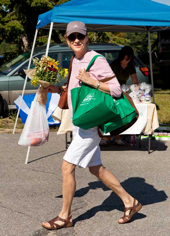 Pat Riemitis dashes through the market with arms full of purchases.