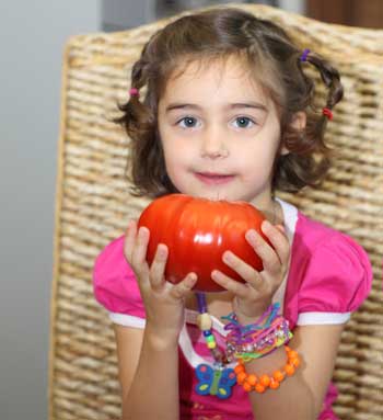 Nora Clarke shows off her giant Early Girl tomato. (Photos by Lisa Aciukewicz) Nora Clarke shows off her giant Early Girl tomato. (Photos by Lisa Aciukewicz)
