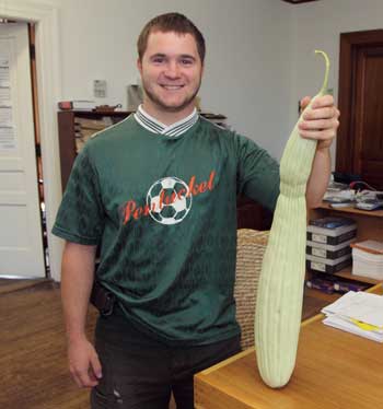 Tom Cooke holds up an exotic cucumber grown by his mother, Lynn. Tom Cooke holds up an exotic cucumber grown by his mother, Lynn.