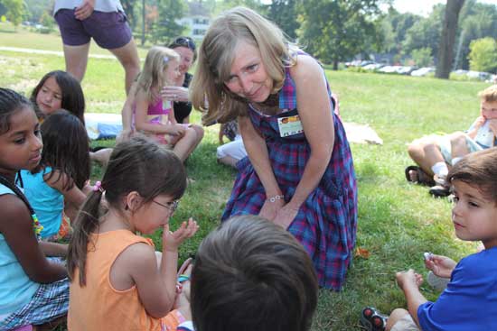 Kindergarten teacher Cindy Hanson greets her new students and hears about their summers.