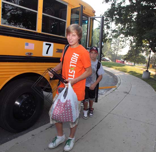 Eighth-grader Nick Norcross gets off the bus at Bromfield.