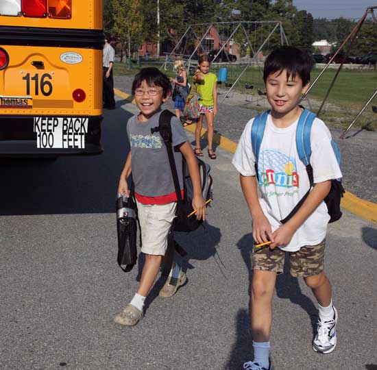 Fifth-graders Jeffrey Young and Evan Bilafer are all smiles as they head into the elementary school.