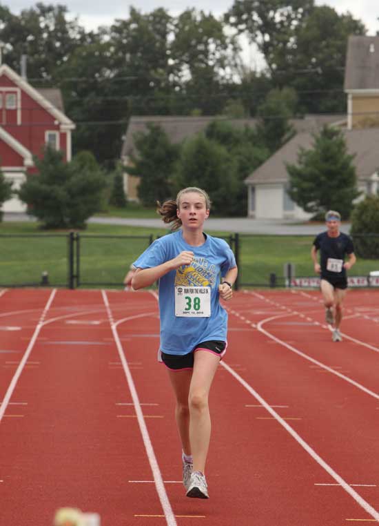 Sophia Collins heads for the finish line on the track at McCurdy Park. 