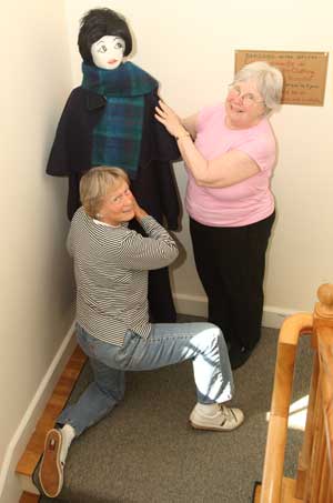 Teddy Coffin (left) and Diane Cordner attire Molly the mannequin on the stairway to Bargains in the Belfry at the Harvard Unitarian Universalist Church on the Common. (Photo by Lisa Aciukewicz) Teddy Coffin (left) and Diane Cordner attire Molly the mannequin on the stairway to Bargains in the Belfry at the Harvard Unitarian Universalist Church on the Common. (Photo by Lisa Aciukewicz)