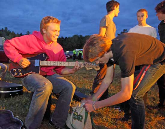 Will Byler (with guitar) and Phil Stapleton on The Hot Susannahs prepare to take the stage at the Lions Club Fall Festival Battle of the Bands on Sept. 17.